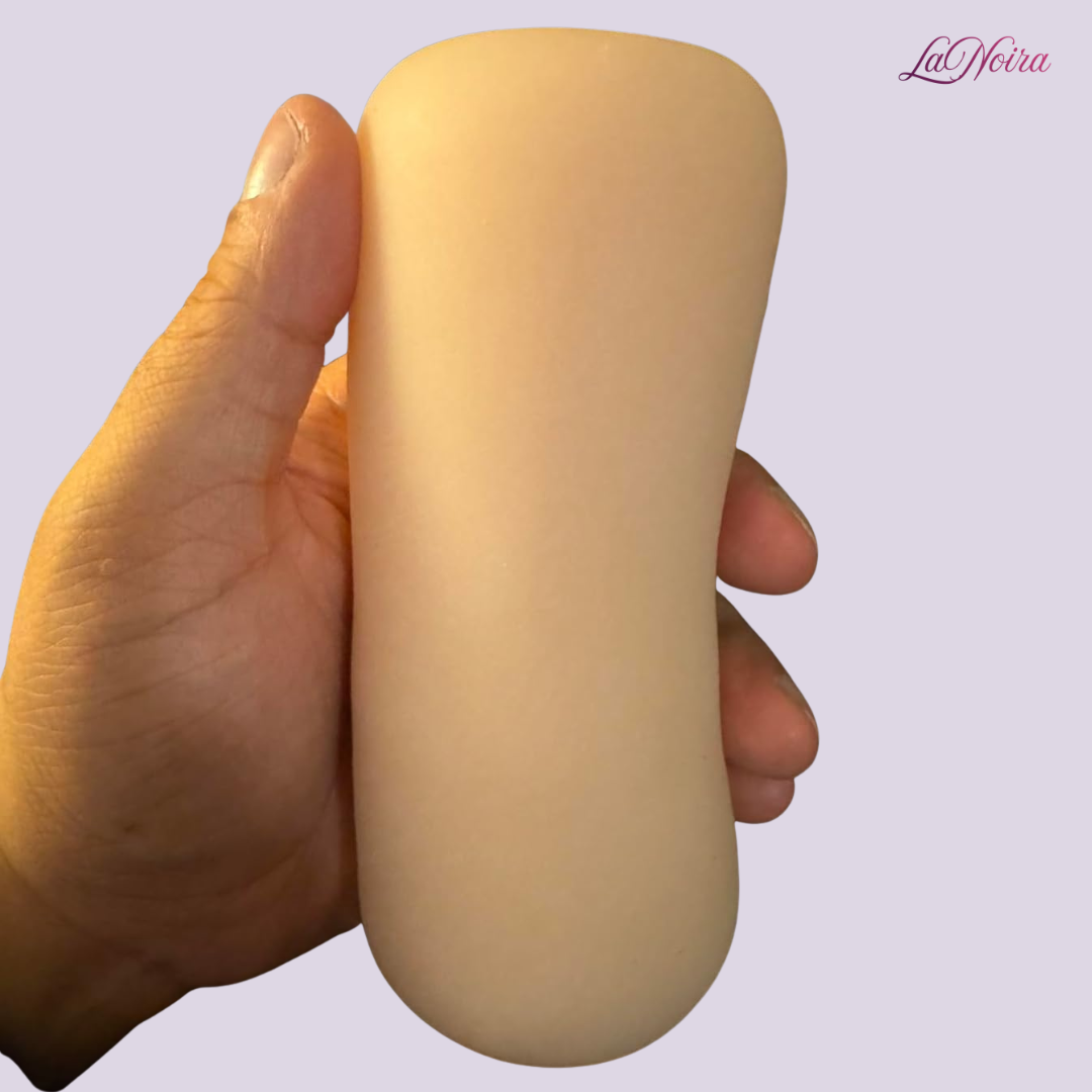 SilkTouch pocket stroker held in hand to illustrate compact size, grip comfort, and cylindrical design