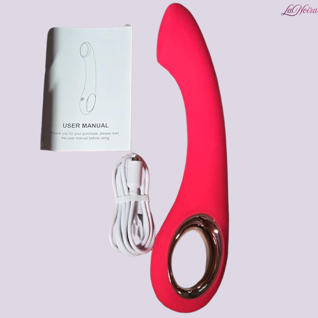 LaNoira Halo pink curved G-spot vibrator with USB charging cable and user manual on light background