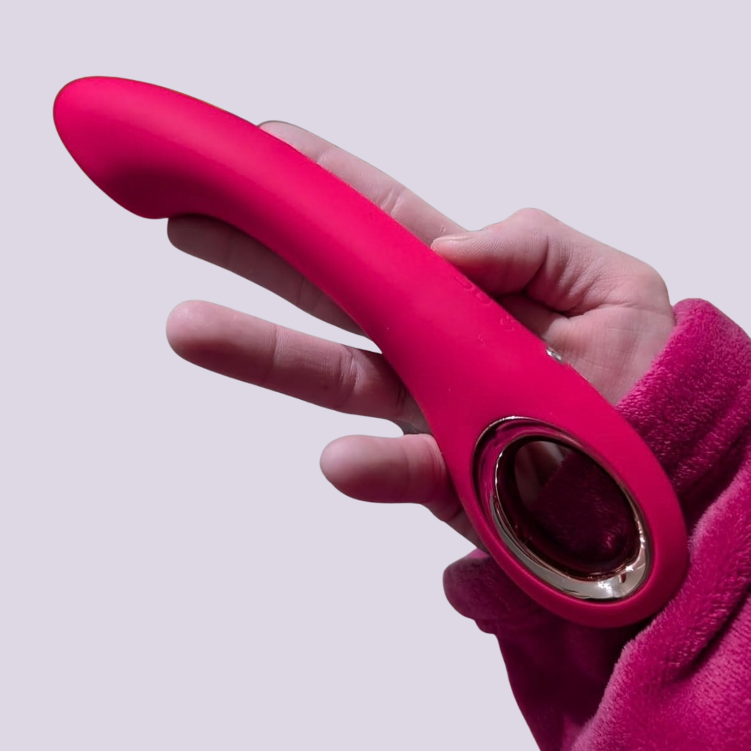 Hand holding LaNoira Halo pink G-spot vibrator demonstrating size, curve, and one-button control design