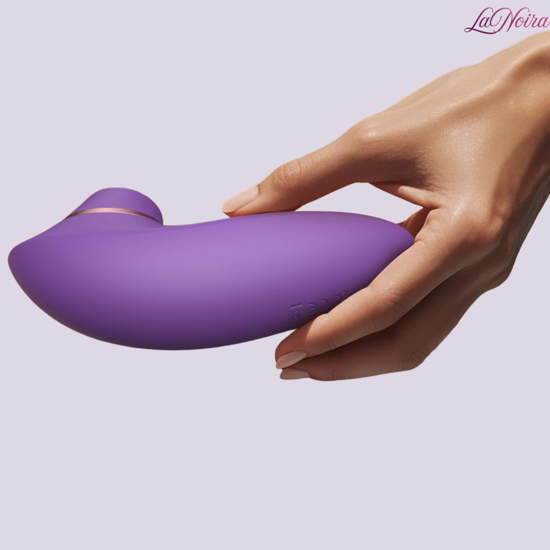 LaNoira Aria clitoral stimulator held in hand highlighting smooth silicone body
