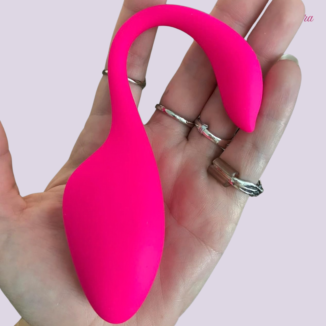 Hand-held LaNoira Carola wearable vibrator showing compact size and smooth silicone finish