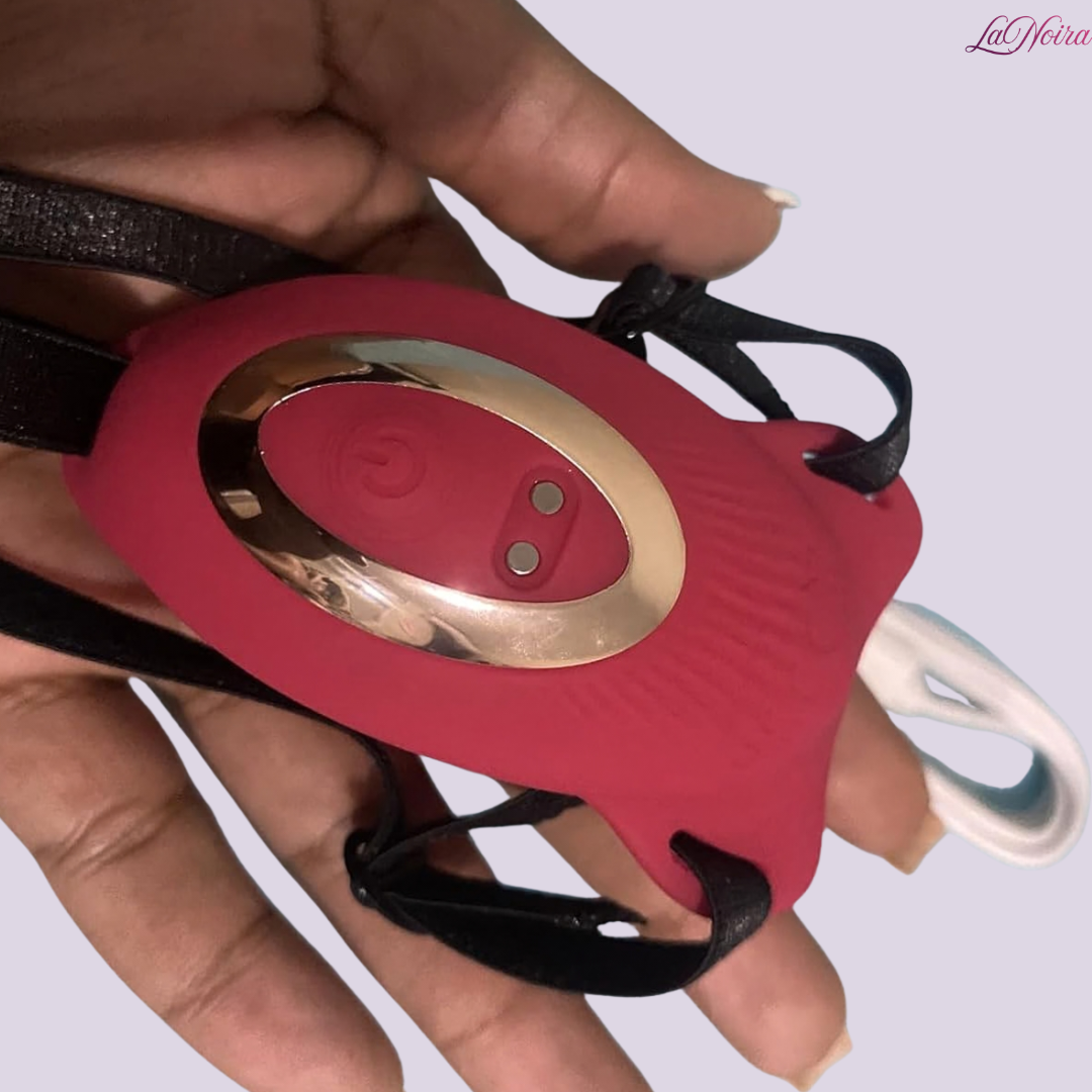 LaNoira RosePulse couples vibrator held in hand showing curved arms, rose-shaped stimulator, and adjustable strap