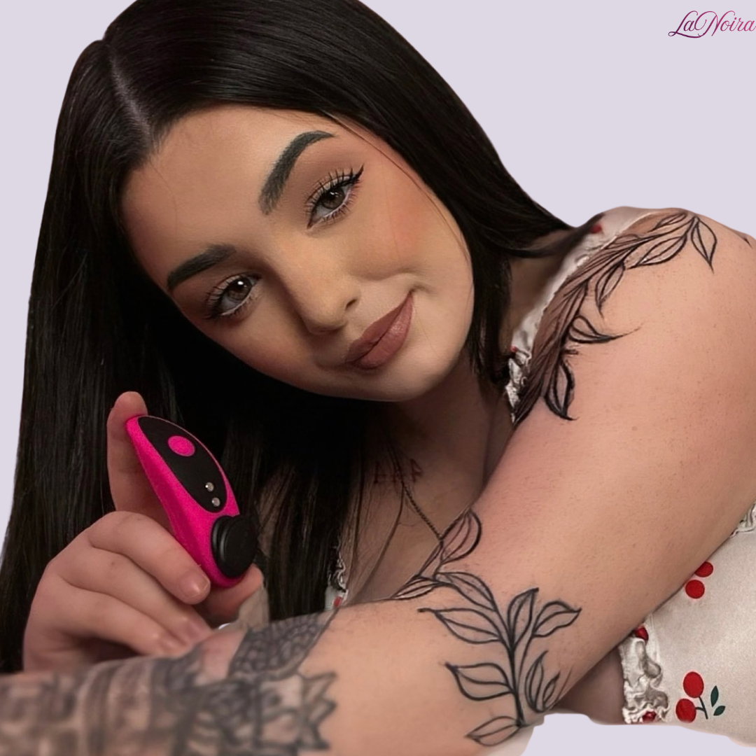 Lovense Ferri wearable panty vibrator held in hand, showing compact pink and black design