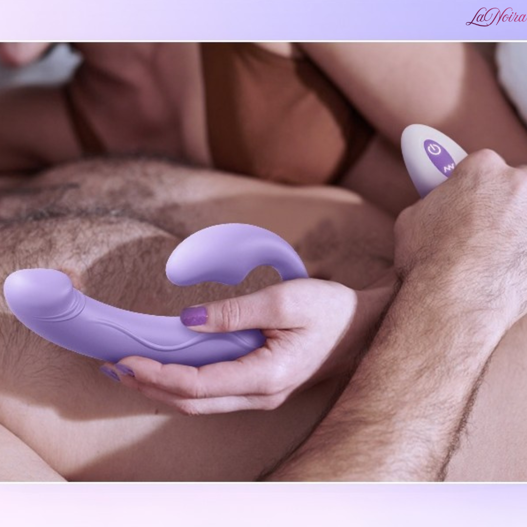Tracy’s Dog Cushify strapless strap-on vibrator held in hand with remote control, illustrating couple-friendly use