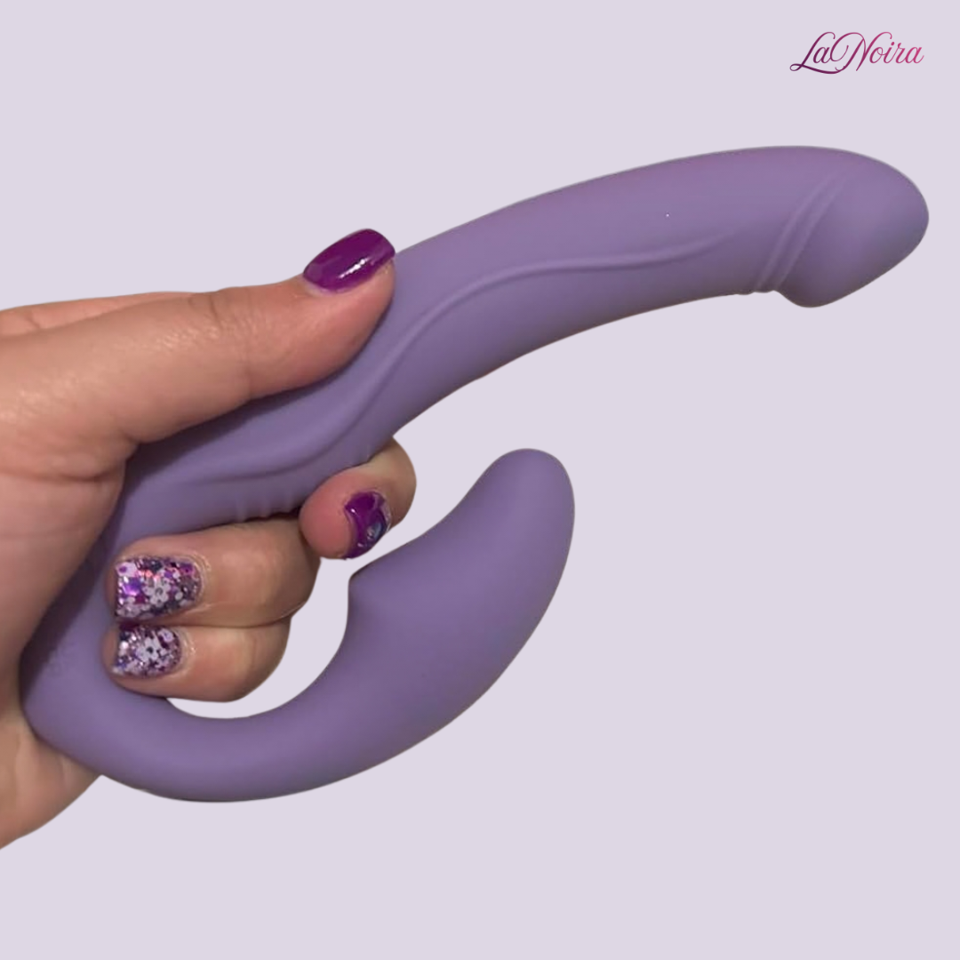 Tracy’s Dog Cushify strapless strap-on vibrator held in hand showing curved ergonomic shape and soft silicone body