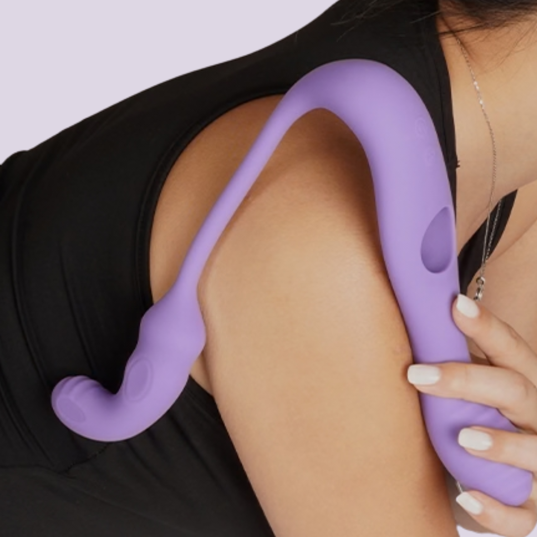 Tracy’s Dog Wizzy flexible purple silicone rabbit vibrator shown draped over shoulder to demonstrate length and flexibility