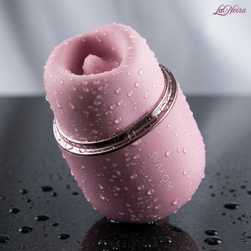 Close-up of the SVAKOM Klitty triple-action clitoral suction and licking massager covered with water droplets, emphasizing waterproof construction – LaNoira India